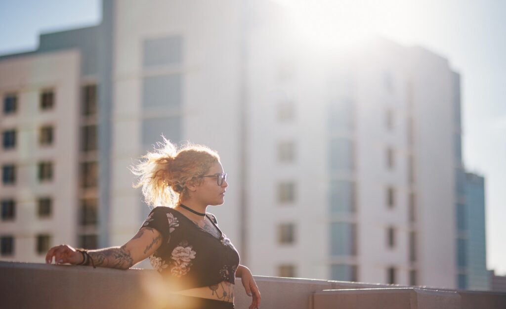 A sensitive person sitting in the sun looking fierce because she said goodbye to a toxic situation.