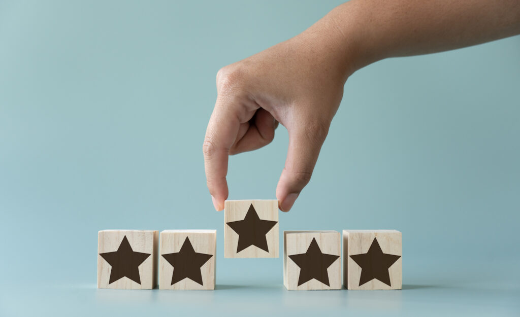 A perfectionist adjusting a set of blocks marked with gold stars to make sure they're perfect