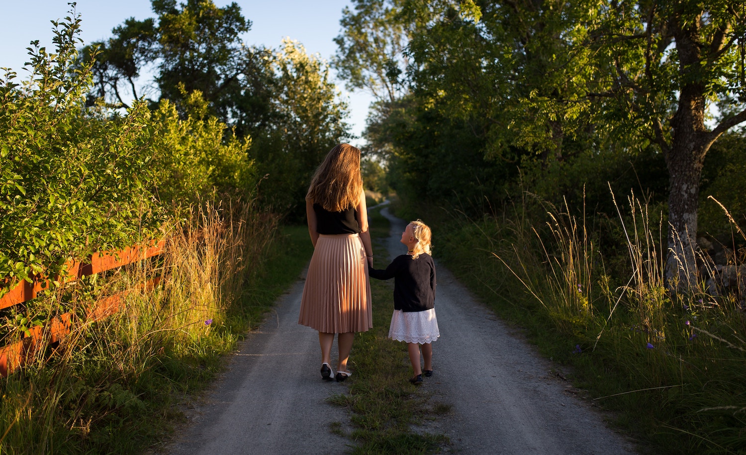 a highly sensitive parent and child walk down a road together