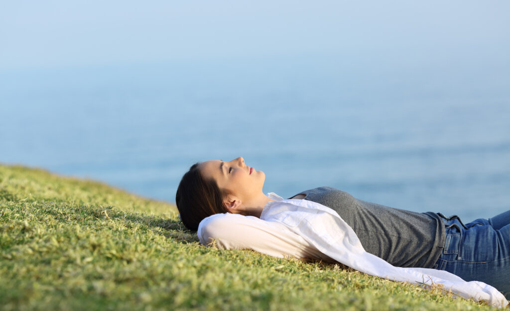 a highly sensitive person alone on a hillside smiling