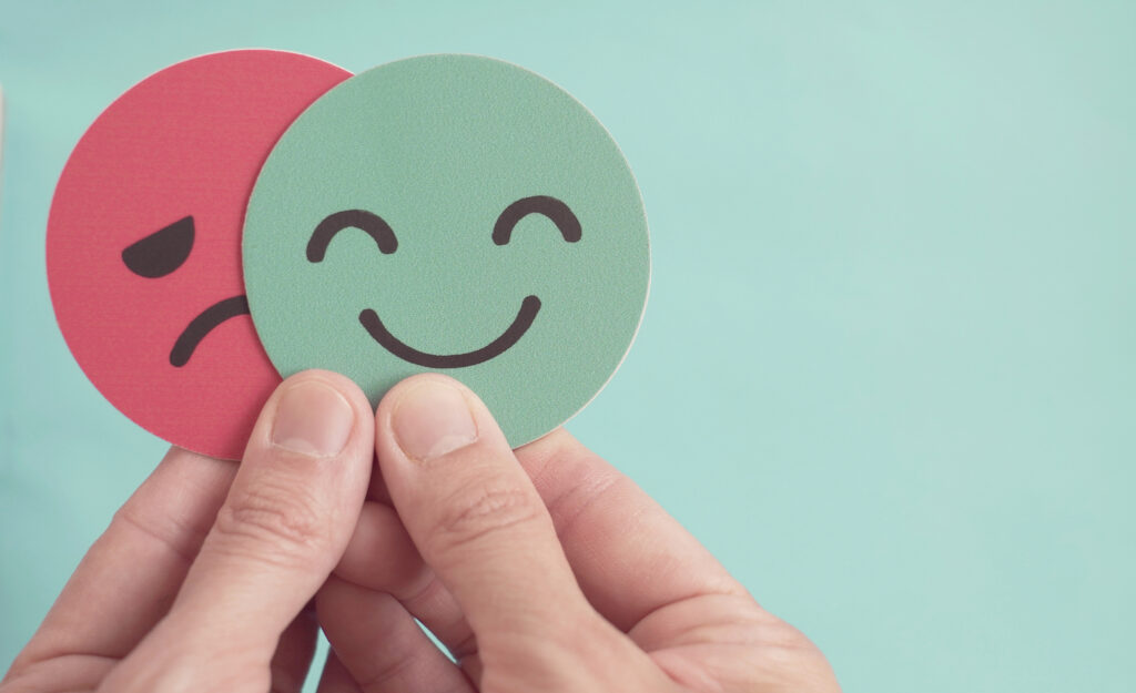 Image of happy and sad faces, suggesting emotions can make you strong or weak