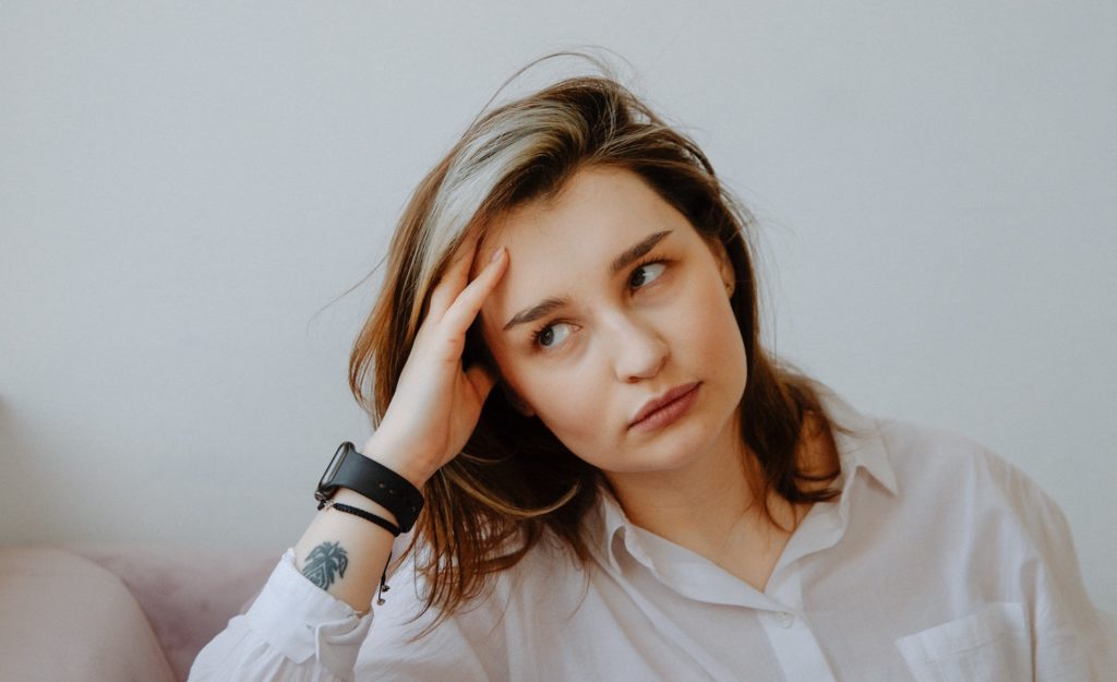 A woman looking annoyed because of gaslighting