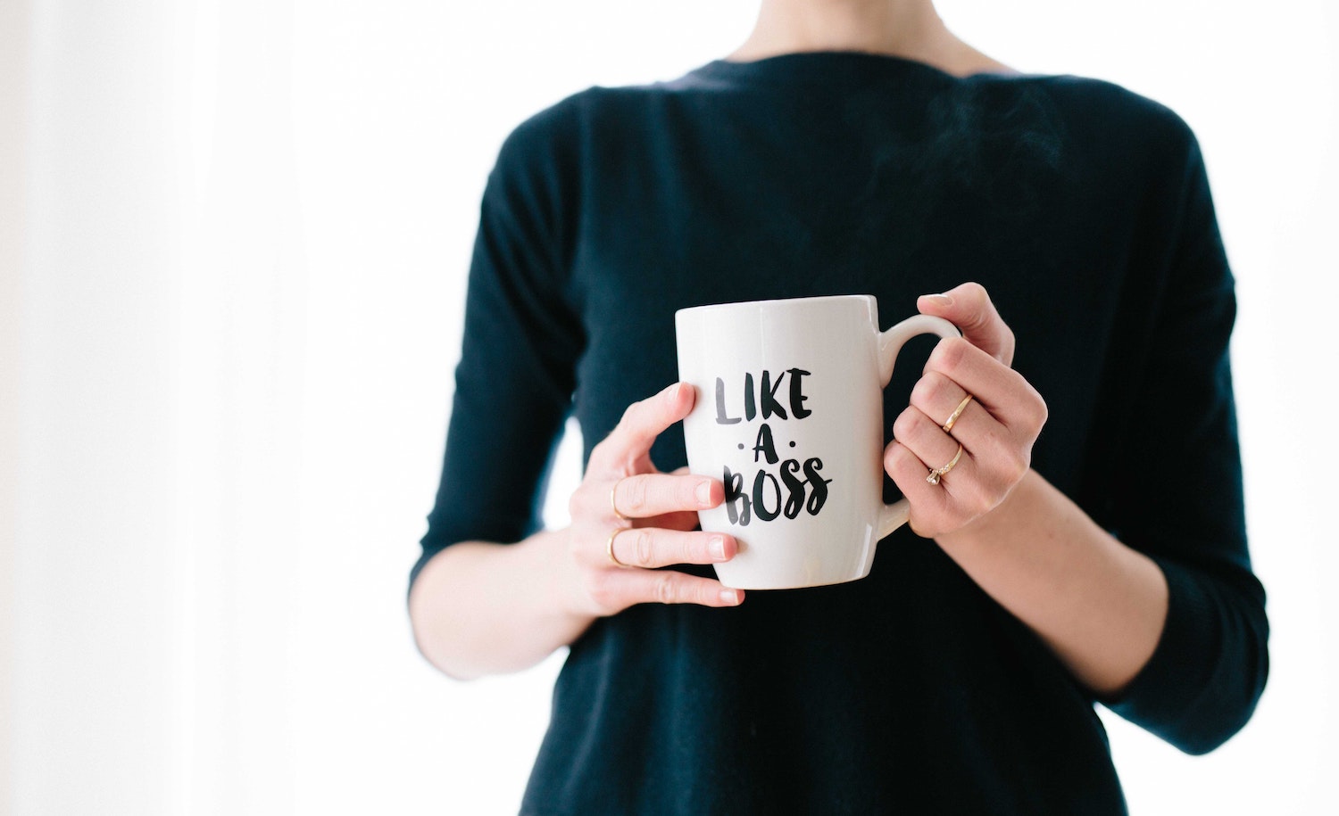 A highly sensitive person (woman) leading and holding a "like a boss" mug