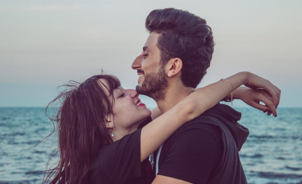 Two highly sensitive people (man and woman) in love, hugging each other on a beach