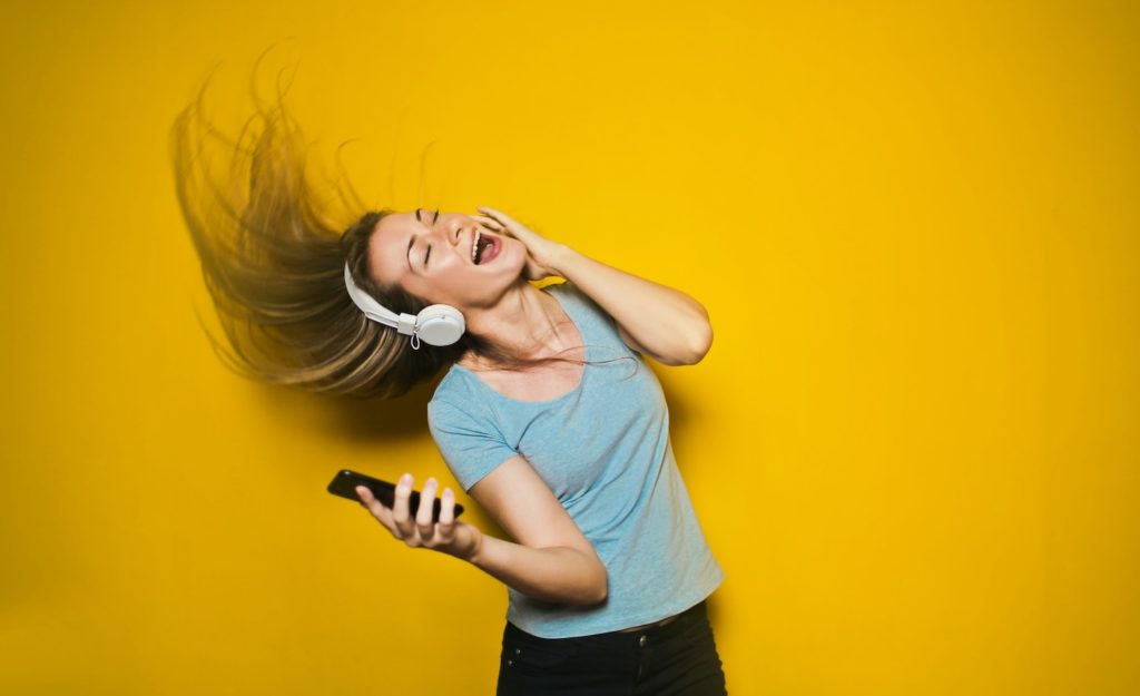 A woman dancing with joy at how great it is to be sensitive.