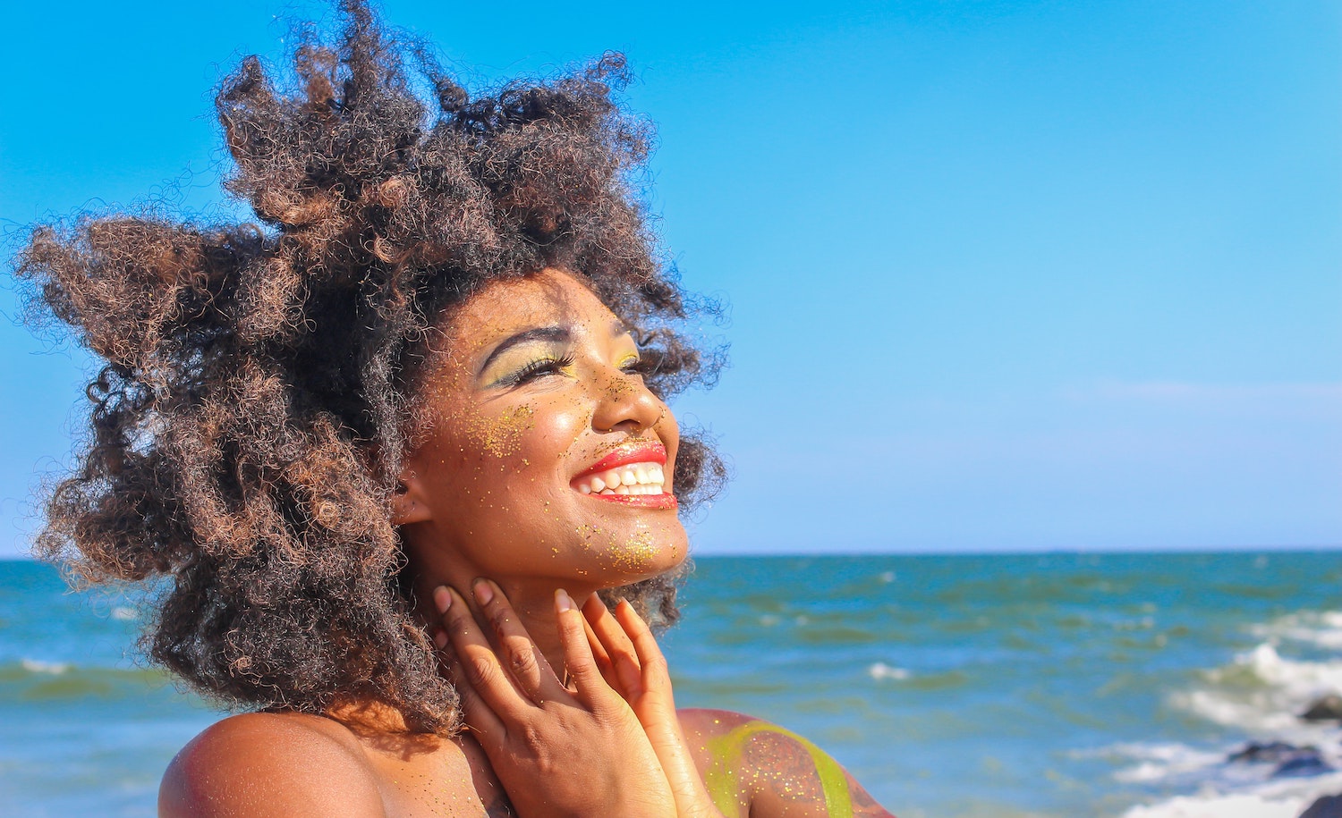 An empath (woman) smiling in the sunshine and living her best life.