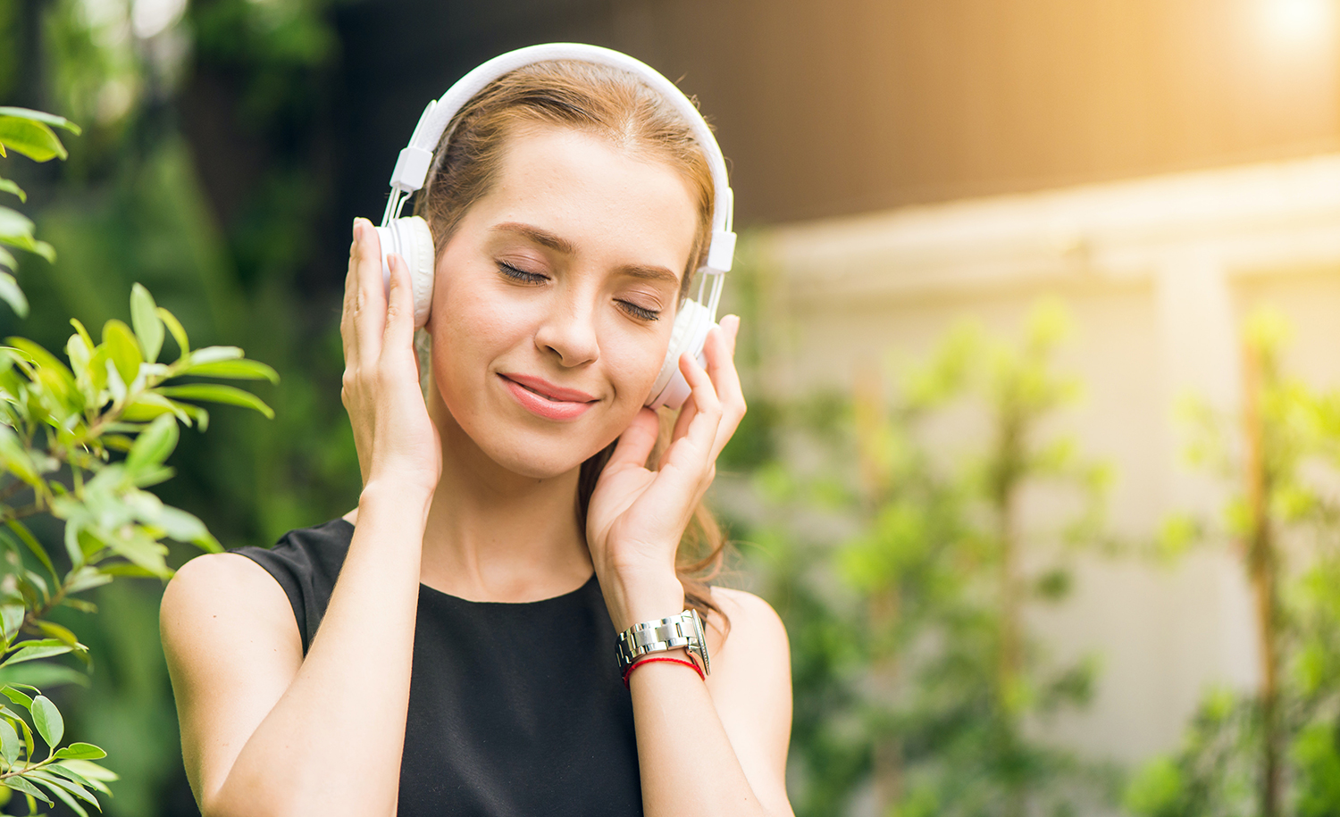 A highly sensitive person listens to an ASMR audio clip on headphones