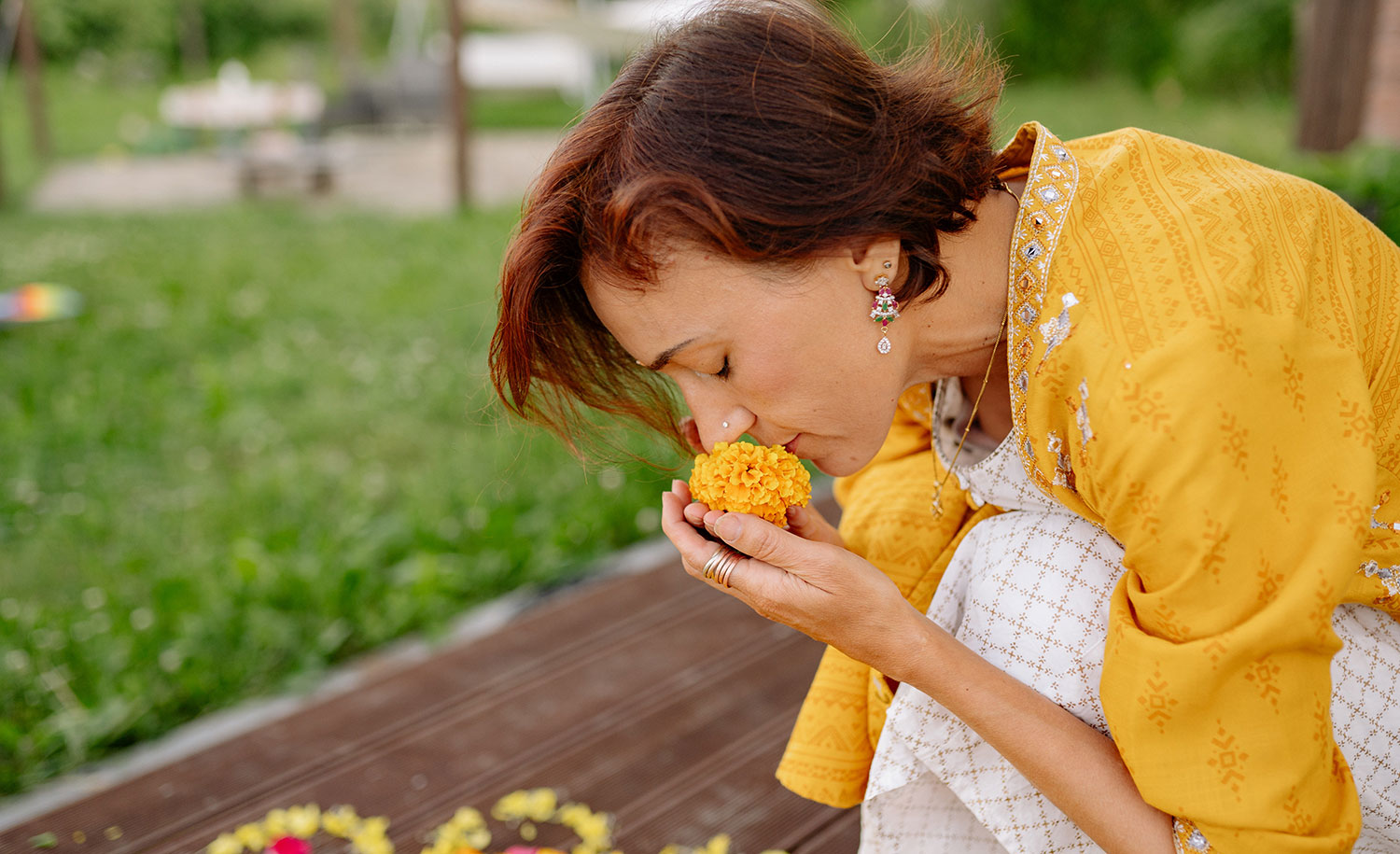 A highly sensitive woman smelling a flower