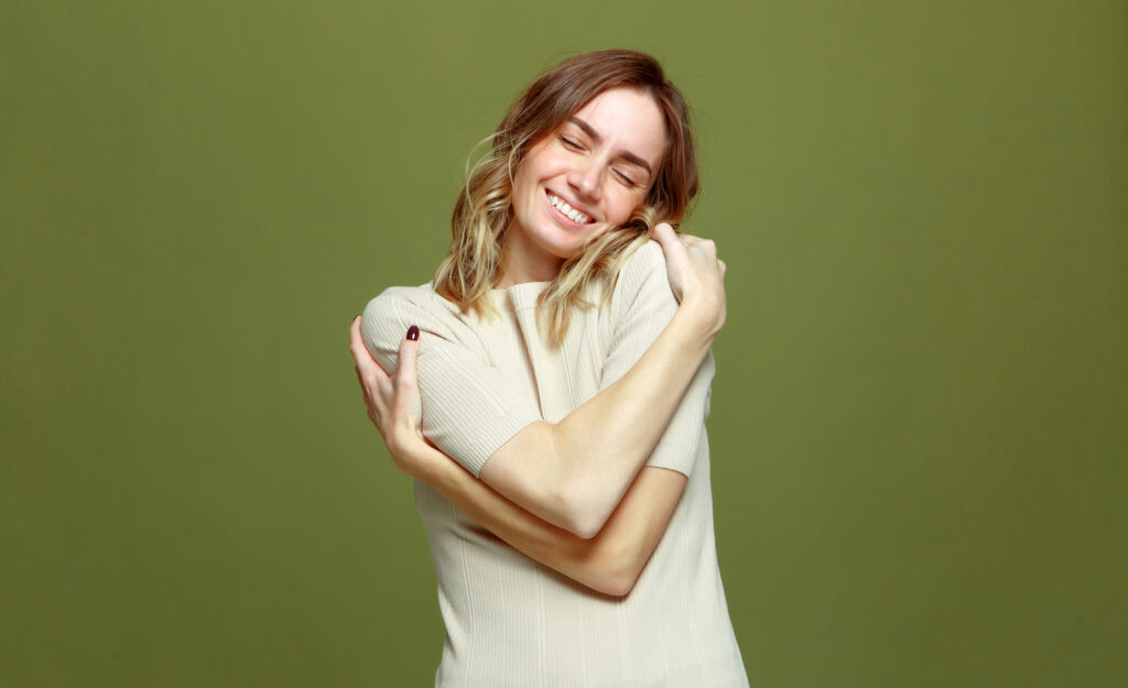 A highly sensitive person embracing themselves