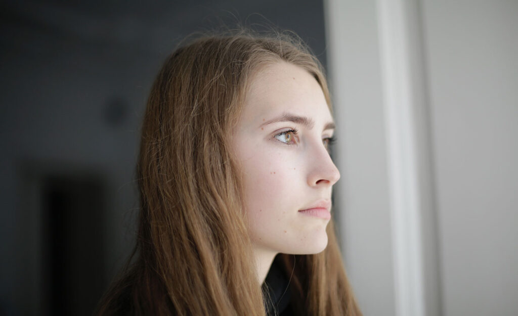 A pensive woman looks off