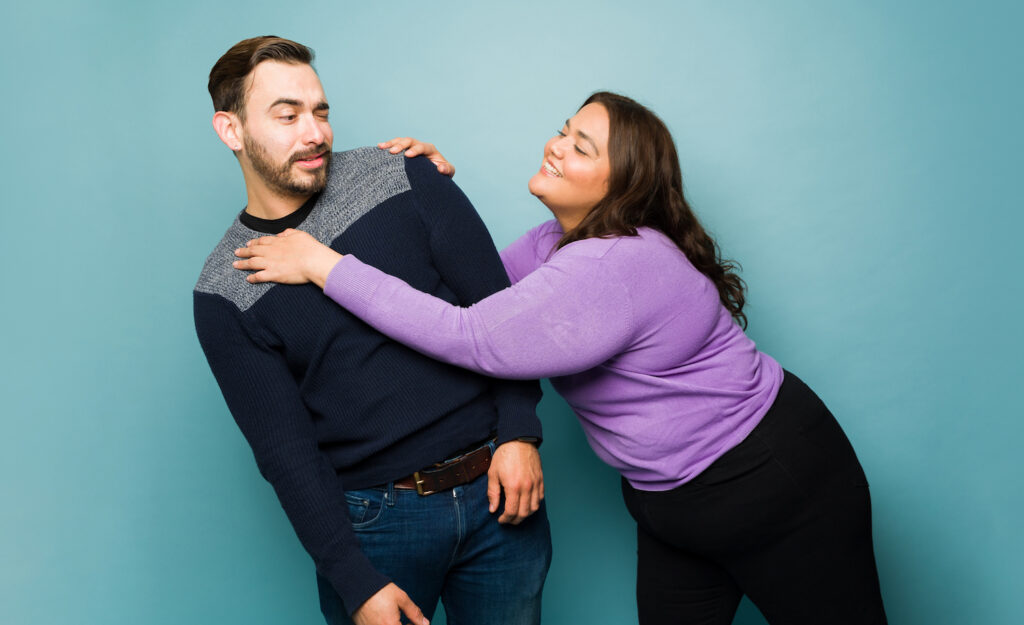 A person invading a highly sensitive person's personal space while he leans away looking uncomfortable