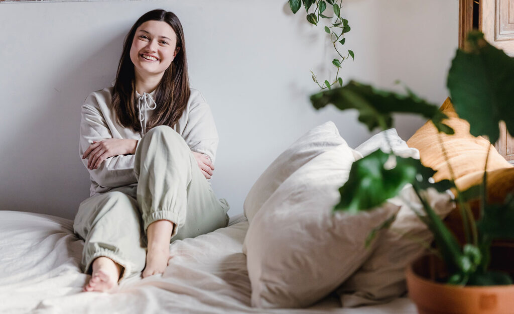A highly sensitive person relaxes on her bed