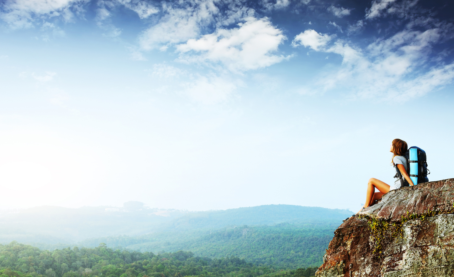 A highly sensitive person sits comfortably on top of a cliff gazing at the sky