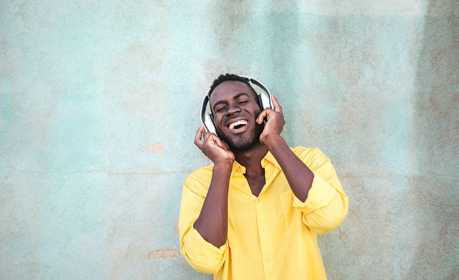 A man smiles while he listens to music