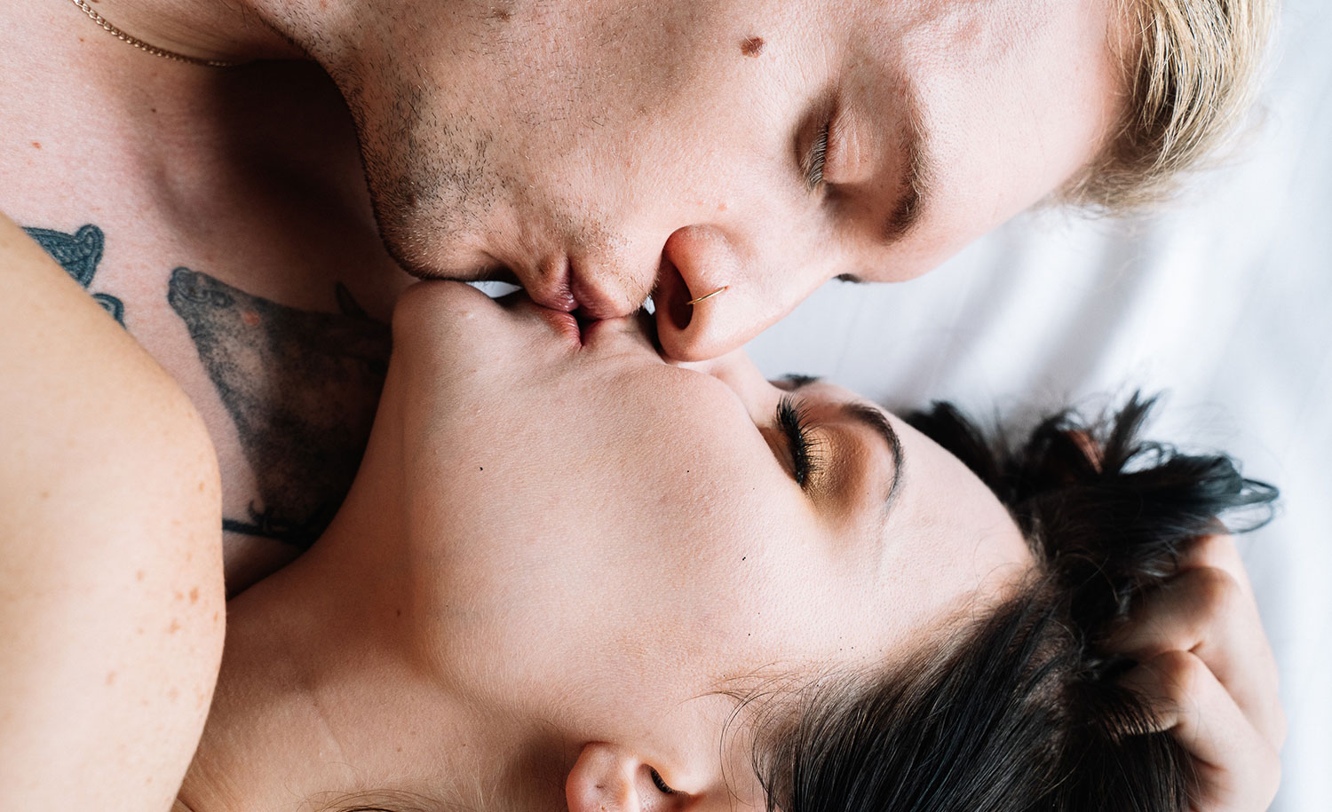 A sensitive man passionately kissing his female partner