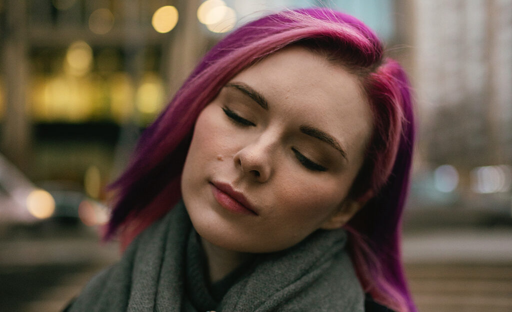 A sensitive person closes her eyes and reflects on her harmful thought patterns