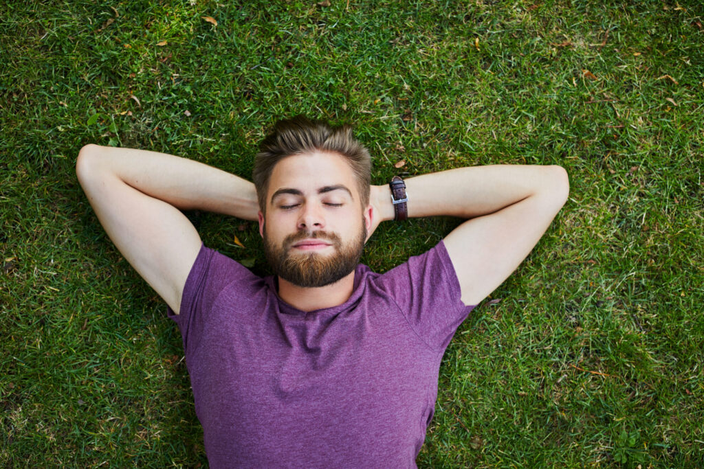 A highly sensitive man lying on grass