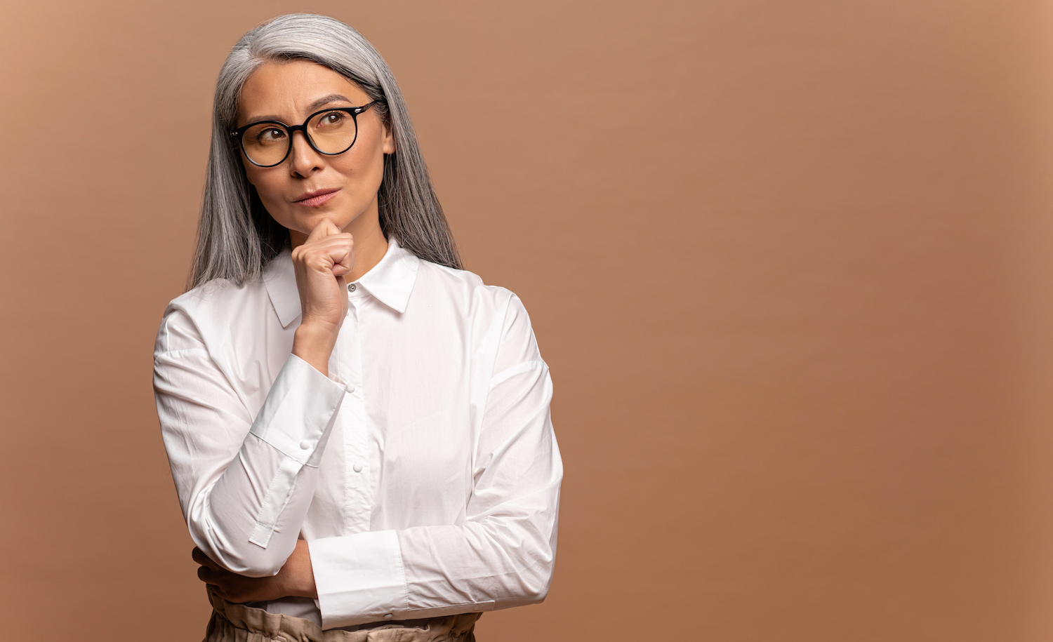 A woman looking thoughtfully to the side with the words, “Scientists Believe We Have More Than 5 Senses. What Does That Mean for Highly Sensitive People?”